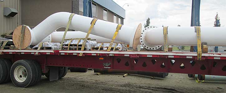 Large Pipes Being Transported On a Truck